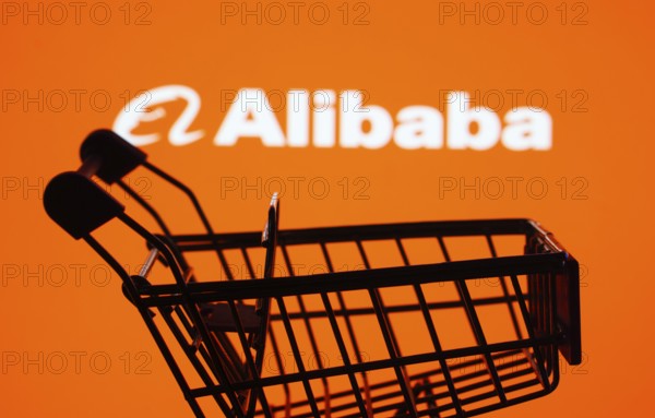 Dhaka, Bangladesh- 03 July 2025: Silhouette of a shopping cart in front of the Alibaba logo, symbolizing ecommerce and online shopping