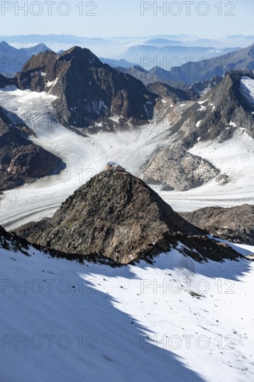 At the Wilder Freiger summit, picturesque high mountain landscape with snow, view of the Übeltalferner glacier and rocky mountain peaks Becher with Becherhaus and Königshofspitz, Stubai Alps, South Tyrol, Italy