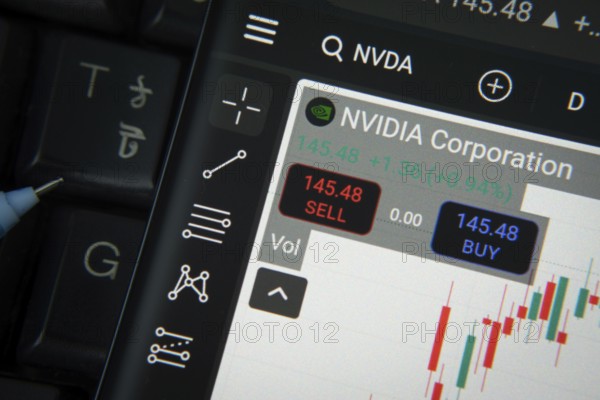 Dhaka, Bangladesh- 20 June 2025: Nvidia corporation stock trading details on smartphone over a keyboard