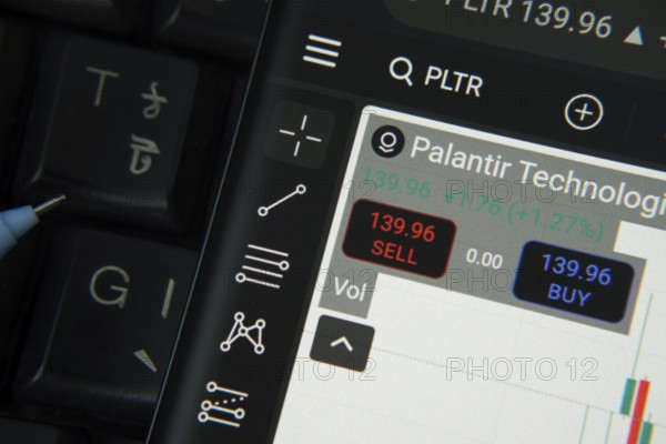 Dhaka, Bangladesh- 20 June 2025: palantir technologies stock trading details on smartphone over a keyboard