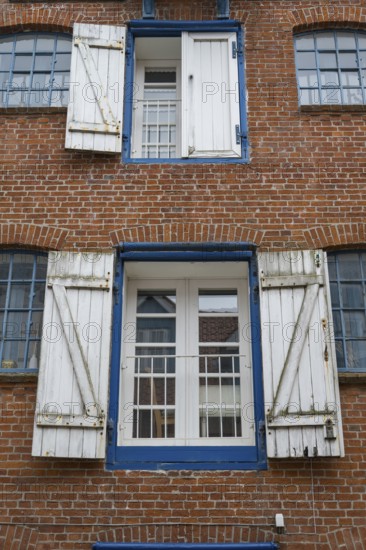 Window with shutters, brick façade, warehouse building, old town centre, Husum, North Frisia, Schleswig-Holstein, Germany