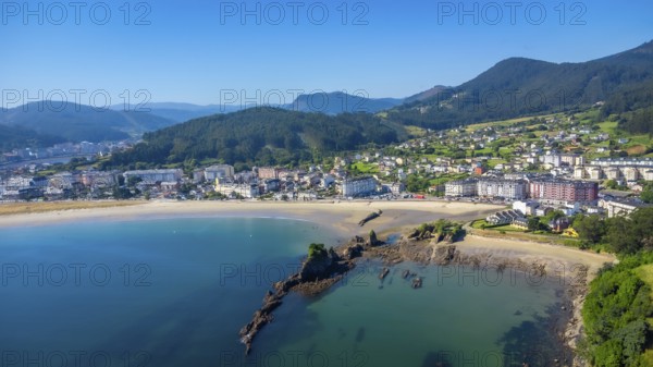 Aerial view of covas beach meeting the charming town of viveiro, nestled amidst the stunning landscapes of galicia, spain, on a sunny summer day