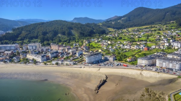 Breathtaking aerial view showcasing the serene beauty of covas beach curving along the coastline, with the picturesque town of viveiro nestled in lush greenery