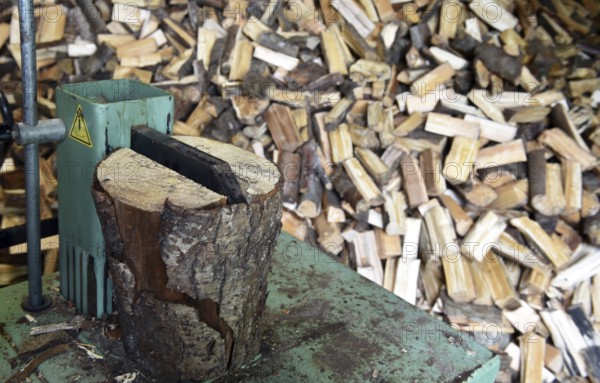 Firewood, splitting with a log splitter, axe