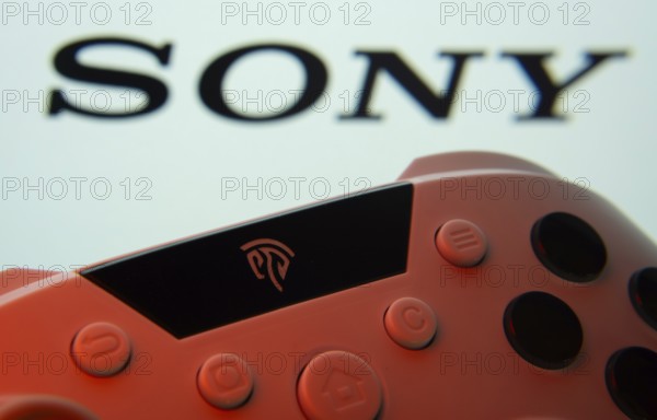 Dhaka, Bangladesh- 02 July 2025: A close-up of a gamepad with the sony seen on screen in the background