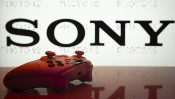 Dhaka, Bangladesh- 03 July 2025: Game controller in front of Sony logo on a background