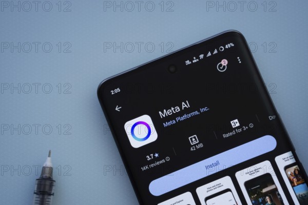 Dhaka, Bangladesh- 29 May 2025: On a blue surface, a smartphone displays the Meta AI app within the Google Play Store
