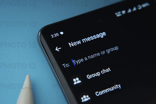 Dhaka, Bangladesh- 04 July 2025: Dhaka, Bangladesh- 17 March 2025: Smartphone displaying WhatsApp new message interface with group chat and community options on a blue background