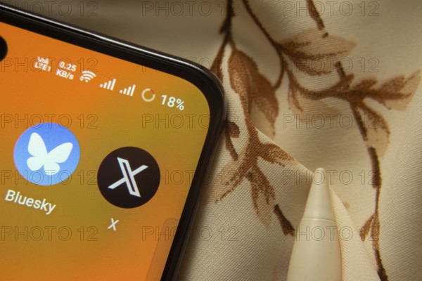 Dhaka, Bangladesh- 07 May 2025: Bluesky and X app icon is seen on smartphone