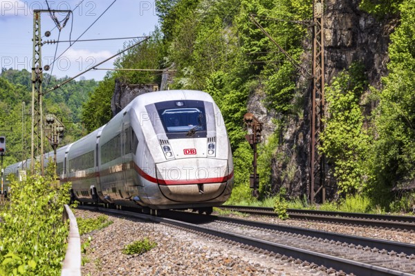 InterCityExpress ICE en route on the winding railway line of the Geislinger Steige. Landscape on the railway's Filstalline line in spring. Amstetten, Baden-Württemberg, Germany
