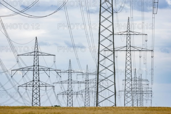 Many high-voltage power lines and lattice towers in the district of Ludwigsburg near Besigheim, Baden-Württemberg, Germany