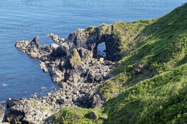 Rocky coast and rock gate on the south-east coast near the southern tip of Cornwall on the English Channel. Cadgwith, Cornwall, South West England, Great Britain