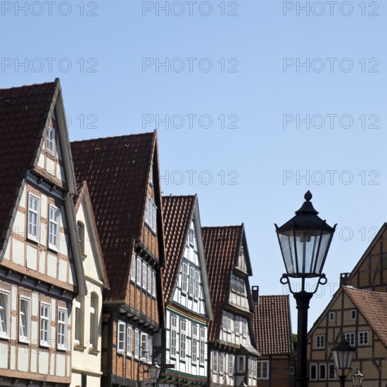 Street with half-timbered houses and historic street lamp in the old town centre, Celle, Lower Saxony, Germany