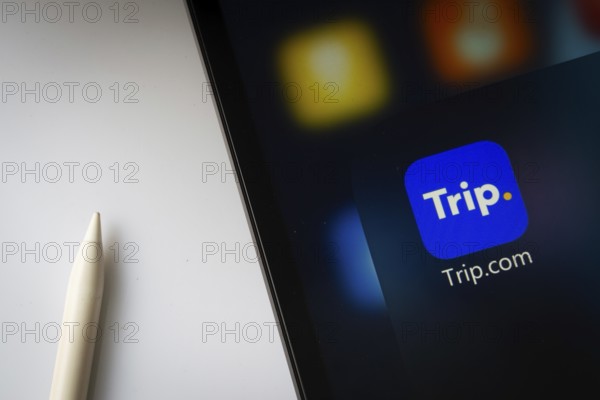 A close up of an iPad screen displaying the trip.com app