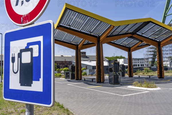 Electric charging station on the site of the former Lohberg colliery in Dinslaken, operated by Fastned, uses electricity from wind power and solar energy, fast-charging columns, with its own solar roof, Lohberg colliery headframe, North Rhine-Westphalia, Germany