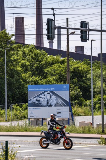 Construction site sign for thyssenkrupp Steel's first direct reduction plant, the climate-neutral steel production project, at the existing steelworks in Duisburg-Farn, pig iron production without a conventional blast furnace but using hydrogen, due to go into operation by the end of 2027, North Rhine-Westphalia, Germany