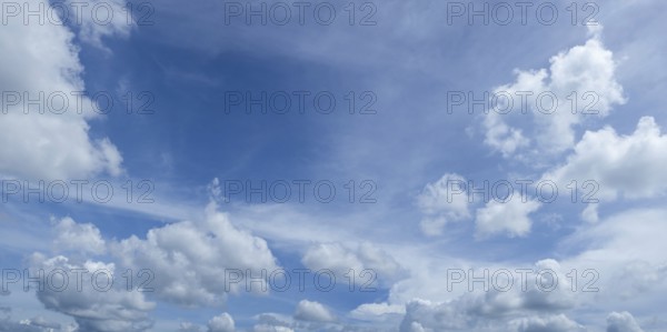 Blue sky with fluffy white clouds creating a serene and peaceful atmosphere
