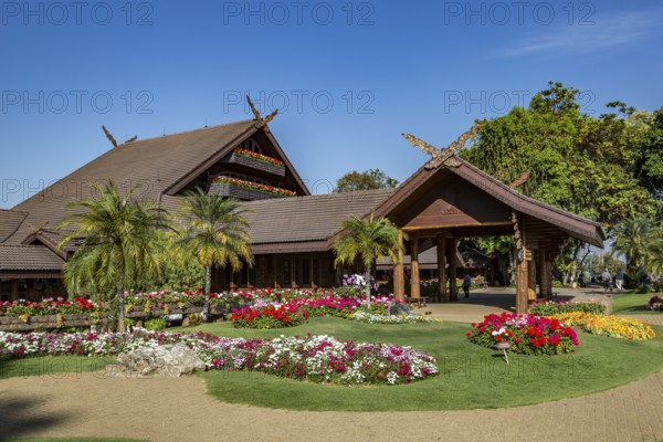 Ornate trees and lush flower gardens enhance the Lanna and Swiss architecture of the Doi Tung Royal Villa inside the Doi Tung tourist attraction in Chiang Rai, Thailand