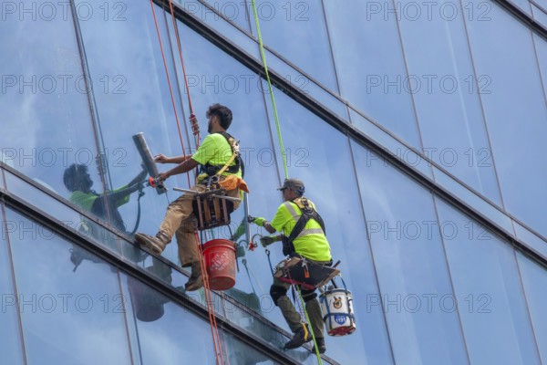 Detroit, Michigan - Window washers at the 25-story Residences Water Square luxury apartment building