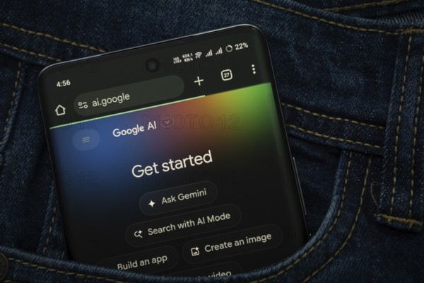 Dhaka, Bangladesh- 15 June 2025: A smartphone displaying the Google AI web interface peeks out of a denim pocket