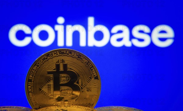 Dhaka, Bangladesh- 16 June 2025: Close-up of Bitcoin coins with the Coinbase logo visible on a screen in the background