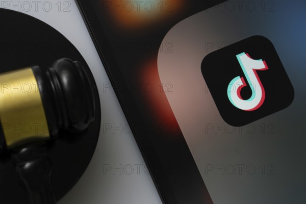 Dhaka, Bangladesh- 18 March 2025: A close up of an iPad screen displaying the tiktok app alongside a judge's gavel