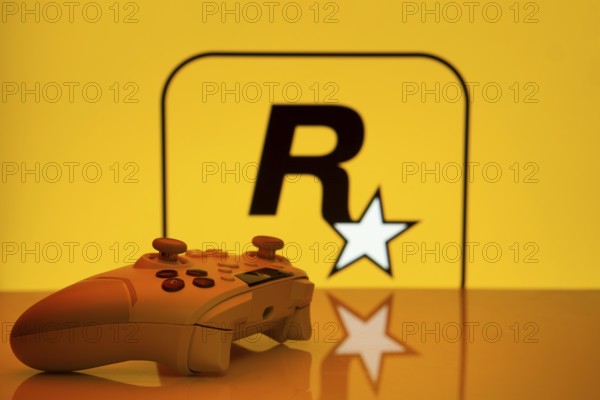 Dhaka, Bangladesh- 17 June 2025: Game controller in front of rockstar games logo on a background