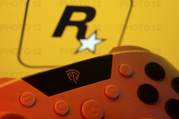 Dhaka, Bangladesh- 12 June 2025: A close-up of a gamepad with the rockstar games seen on screen in the background