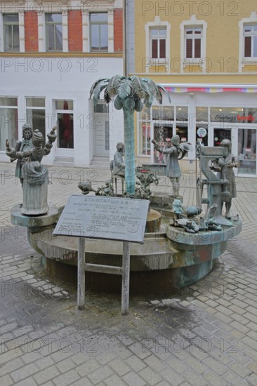 City fountain by Bonifatius Stirnberg 2000, bronze sculptures on the historical city history with symbols for shoemaker tradition, princely couple, noblemen and palm tree for academy, Weißenfels, Saxony-Anhalt, Germany