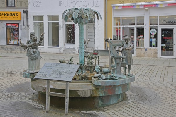 City fountain by Bonifatius Stirnberg 2000, bronze sculptures on the historical city history with symbols for shoemaker tradition, princely couple, noblemen and palm tree for academy, Weißenfels, Saxony-Anhalt, Germany
