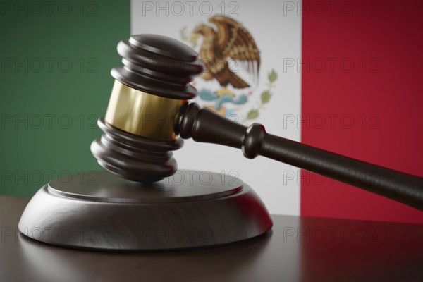 Wooden gavel resting on table in front of mexican flag
