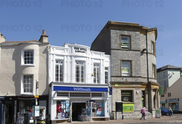 Street and shops including WH Smith in town centre of Teignmouth, south Devon, England, UK