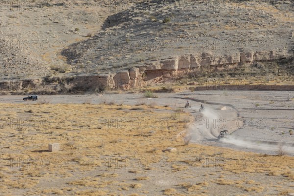 People riding all terrain vehicles through Echo Wash at Echo Bay, Nevada, USA