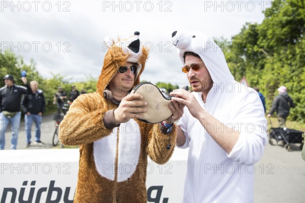 Two festival visitors in animal costumes drink from a horn at the Rock am Ring festival on Friday, Nürburgring race track race track, 06/06/2025