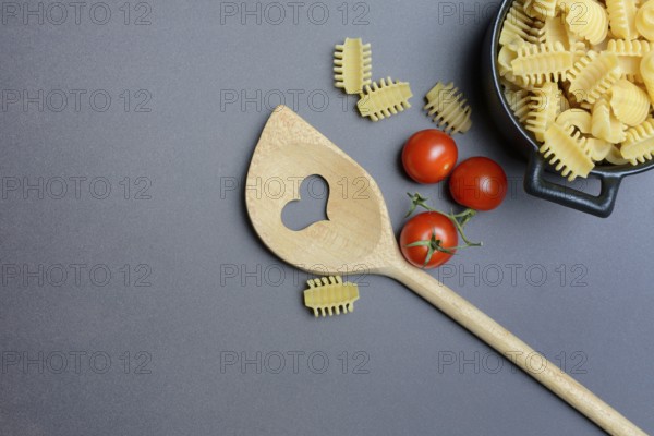 Cooking spoon with heart and Italian pasta, Radiatori variety