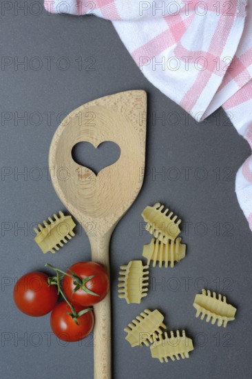 Cooking spoon with heart and Italian pasta, Radiatori variety