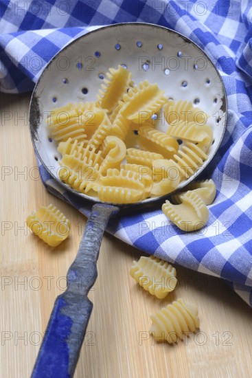 Italian pasta in a sieve, Radiatori variety