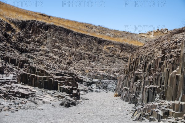 Dry river valley with basalt rocks, rock formation Organ Pipes, Damaraland, Kunene, Namibia