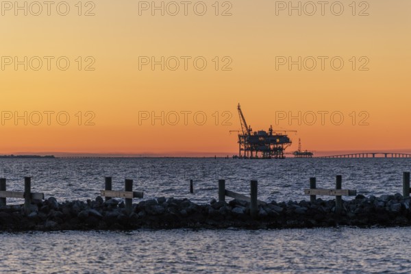 Oil and gas drilling rigs on the Gulf of Mexico horizon at Fort Morgan, Alabama, USA
