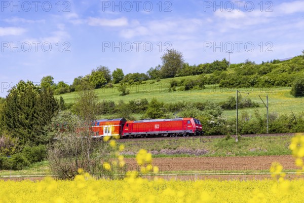 RegionalExpress RE5 en route on the Swabian Alb. Landscape along the railway line in spring. Lonsee, Baden-Württemberg, Germany