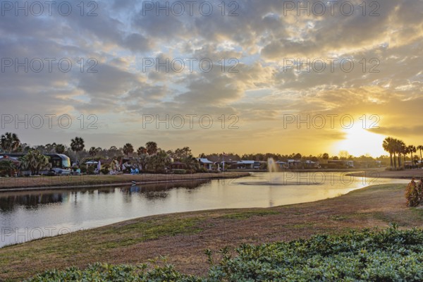 Motorhomes with waterfront lots in RV Resort at sunset in southern Alabama, USA