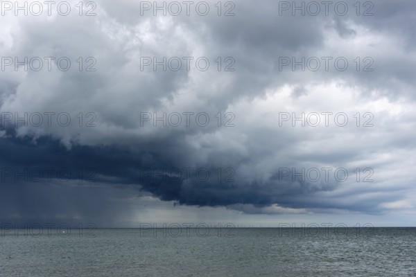 Thick, dark rain clouds gather over the Baltic Sea, Prerow, Mecklenburg-Vorpommern, Germany