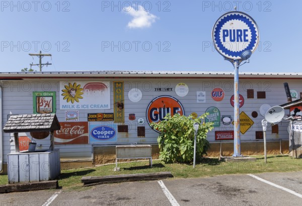 Antique metal advertising signs used for decoration on the side of a building near Counce, Tennessee