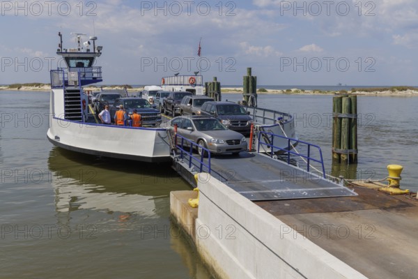 Vehicles driving off the Mobile Bay Ferry at Dauphin Island, Alabama