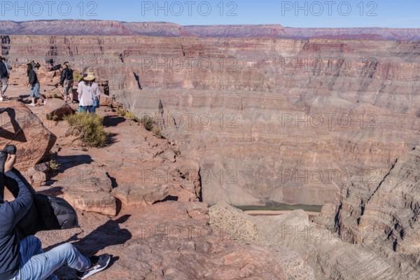 Tourists on the edge of the canyon at Guano Point area of Grand Canyon West near Peach Springs, Arizona