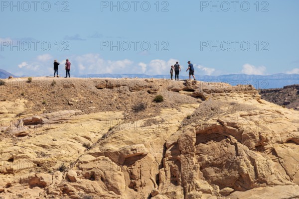 Hikers on the trail to an overlook at the end of Fire Canyon Road at Valley of Fire State Park near Overton, Nevada