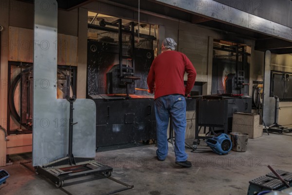 Glass blower demonstrates the art of blowing glass at the Dollywood amusement park in Pigeon Forge, TN