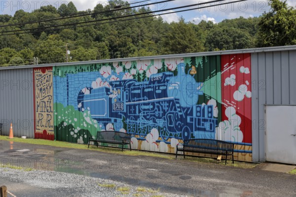 Mural on the back of a building welcomes Great Smoky Mountains Railroad passengers back to Bryson City, North Carolina