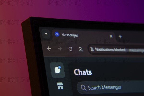 Close-up of a computer screen displaying the Messenger web interface in dark mode