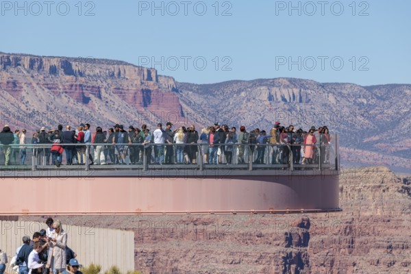 Visitors view the Grand Canyon from the Skybridge, a glass floored bridge extending 70 feet over the canyon at Eagle Point in Grand Canyon West near Peach Springs, Arizona